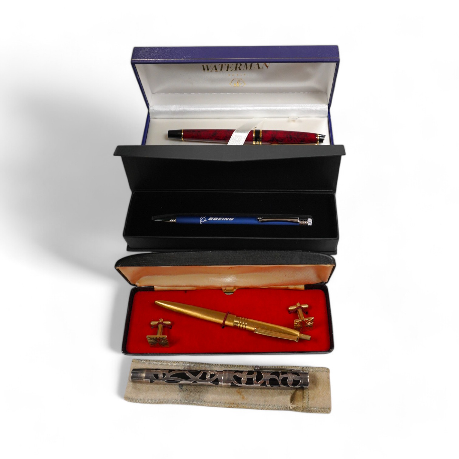 A silver mounted Sheaffer fountain pen, two cased Waterman fountain pens, a ballpoint pen branded for Boeing, and a Queen Elizabeth II pen and cufflink set. Condition - fair to good